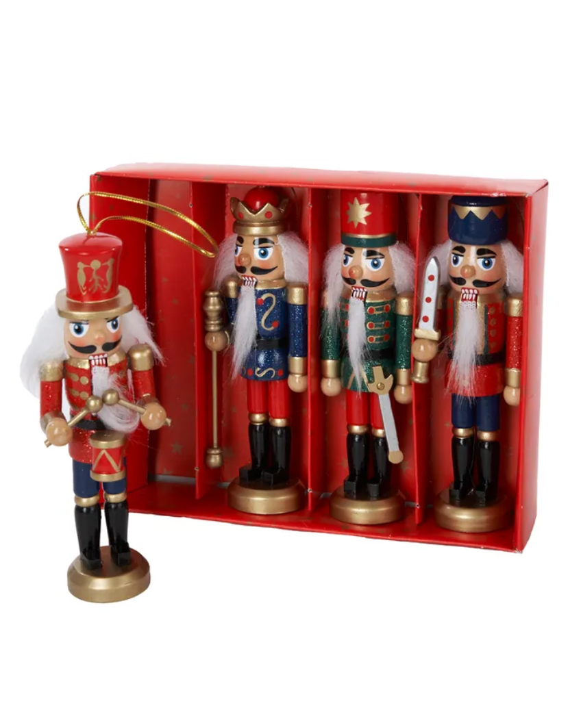 The Canton Christmas Shop 5" wooden nutcracker ornaments four piece set with christmas tree and stocking in background