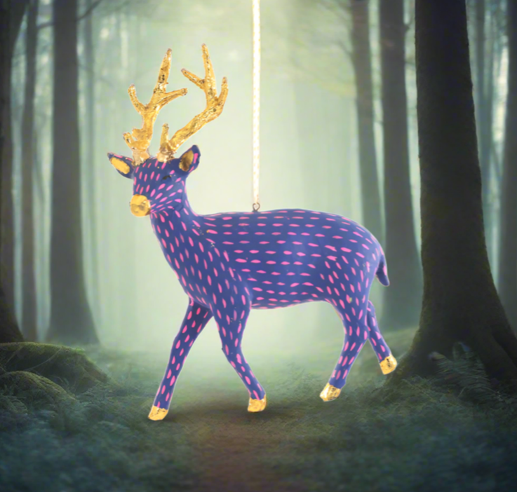 The Canton Christmas Shop Blue and Pink Paper Deer Ornament in magical woods at Christmas