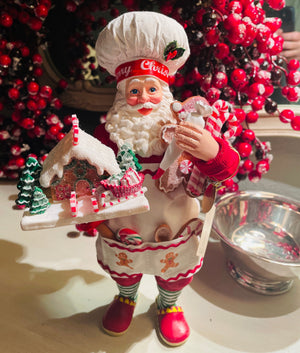 The Canton Christmas Shop 10.5" Fabriché™ Gingerbread Chef Santa with Gingerbread House and Piping Bag