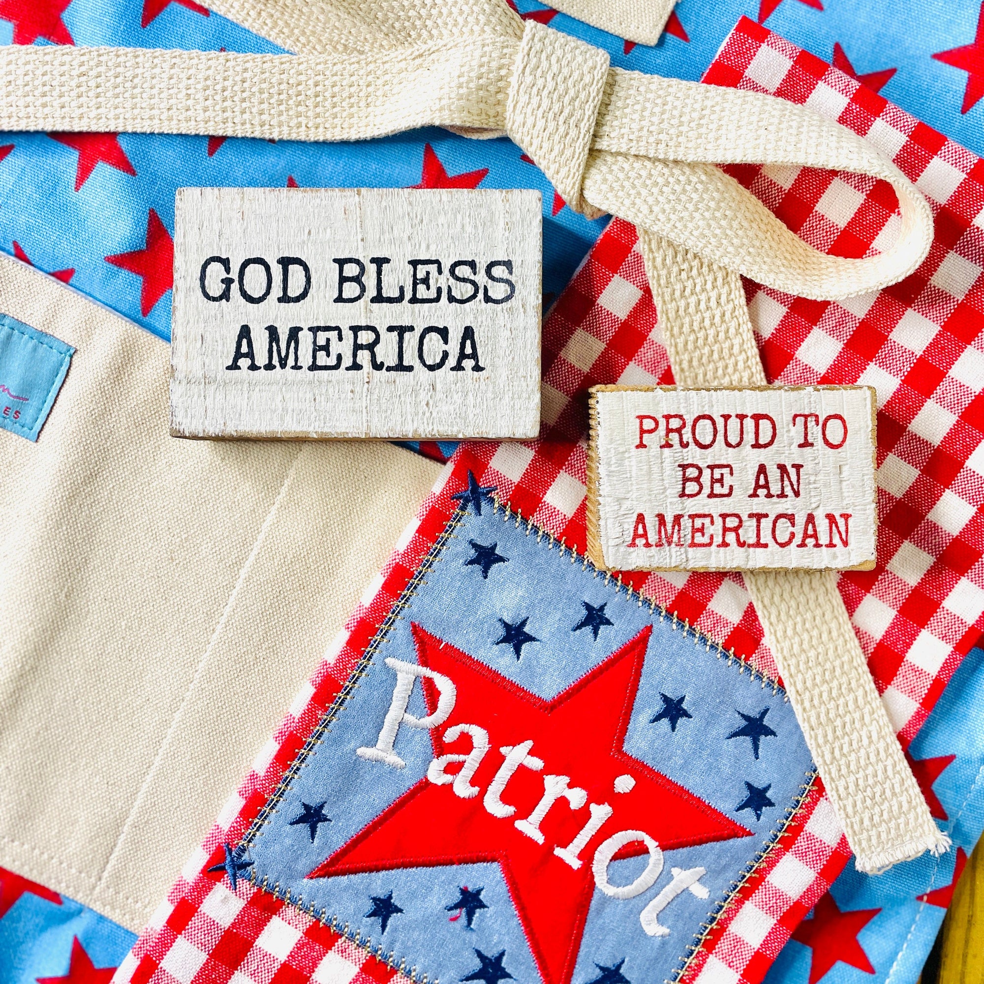 The Canton Christmas Shop Patriot Star Embellished Kitchen Towel hanging outside