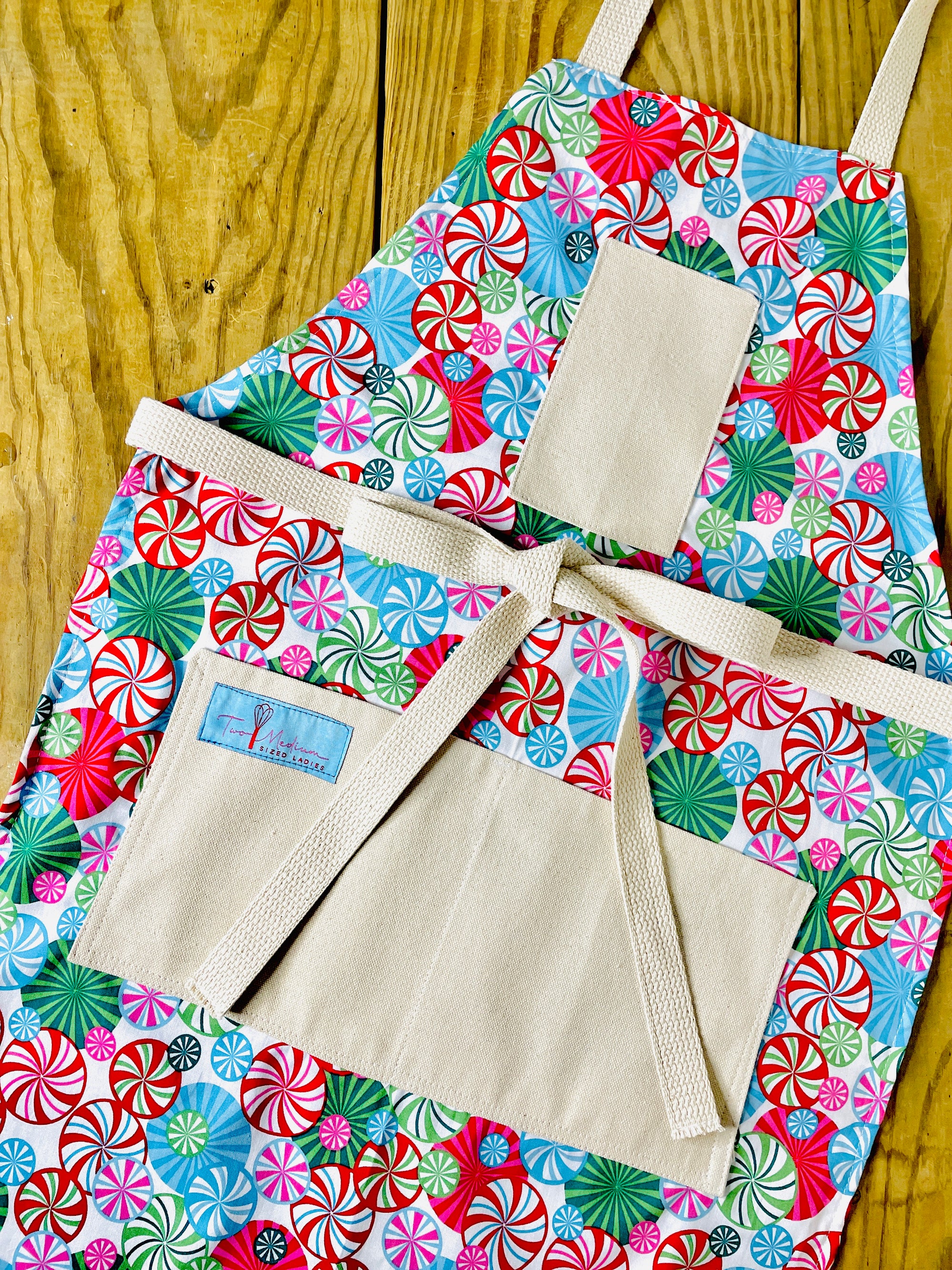 The Canton Christmas Shop Peppermint Lane Christmas Apron with Peppermint Pinwheels by Two Medium Sized Ladies on teenager