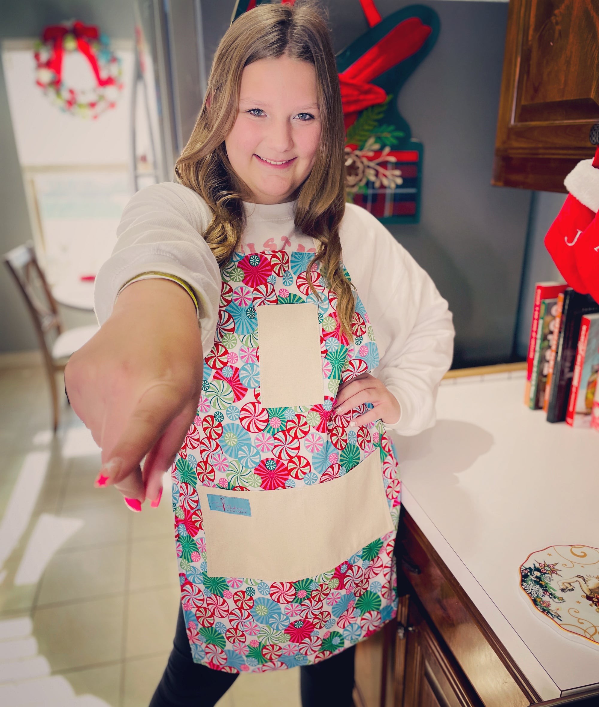 The Canton Christmas Shop Peppermint Lane Christmas Apron with Peppermint Pinwheels by Two Medium Sized Ladies on teenager