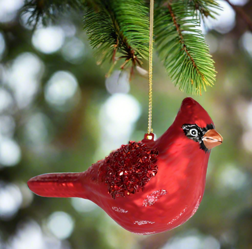 The Canton Christmas Shop Red Cardinal Ornament hanging on a christmas tree