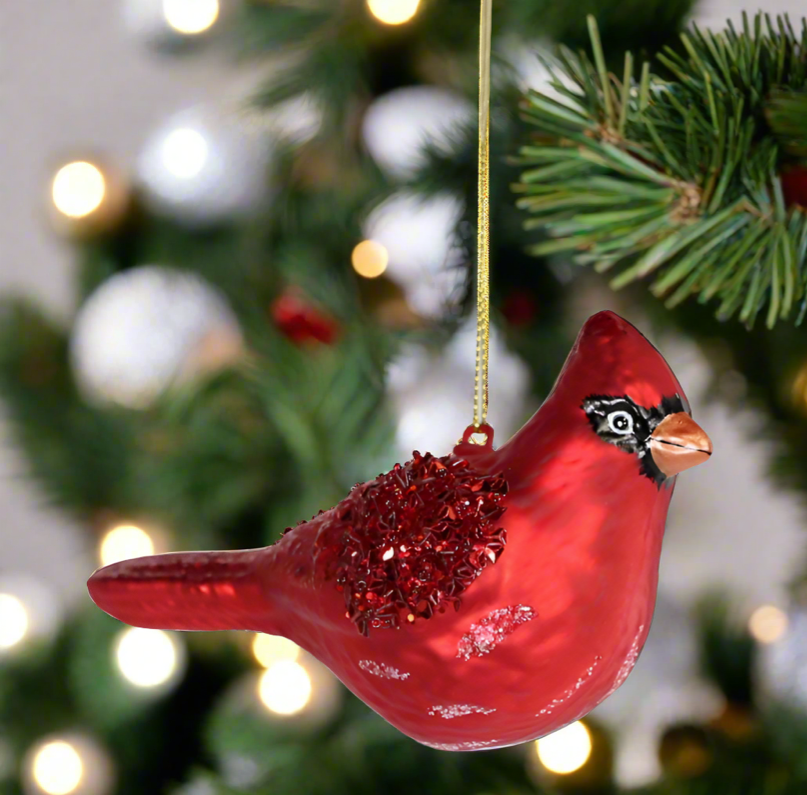 The Canton Christmas Shop Red Cardinal Ornament hanging on a christmas tree