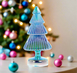 The Canton Christmas Shop Cody Foster Iridescent Lighted Blue Glass Tree in front of a christmas tree