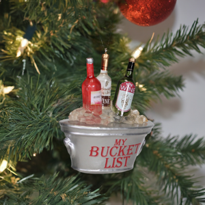 The Canton Christmas Shop Wine Bucket List Glass Ornament hanging from tree branch