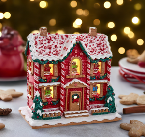 The Canton Christmas Shop 9 1/2" Gingerbread Musical 2 story house by Kurt Adler on Christmas table