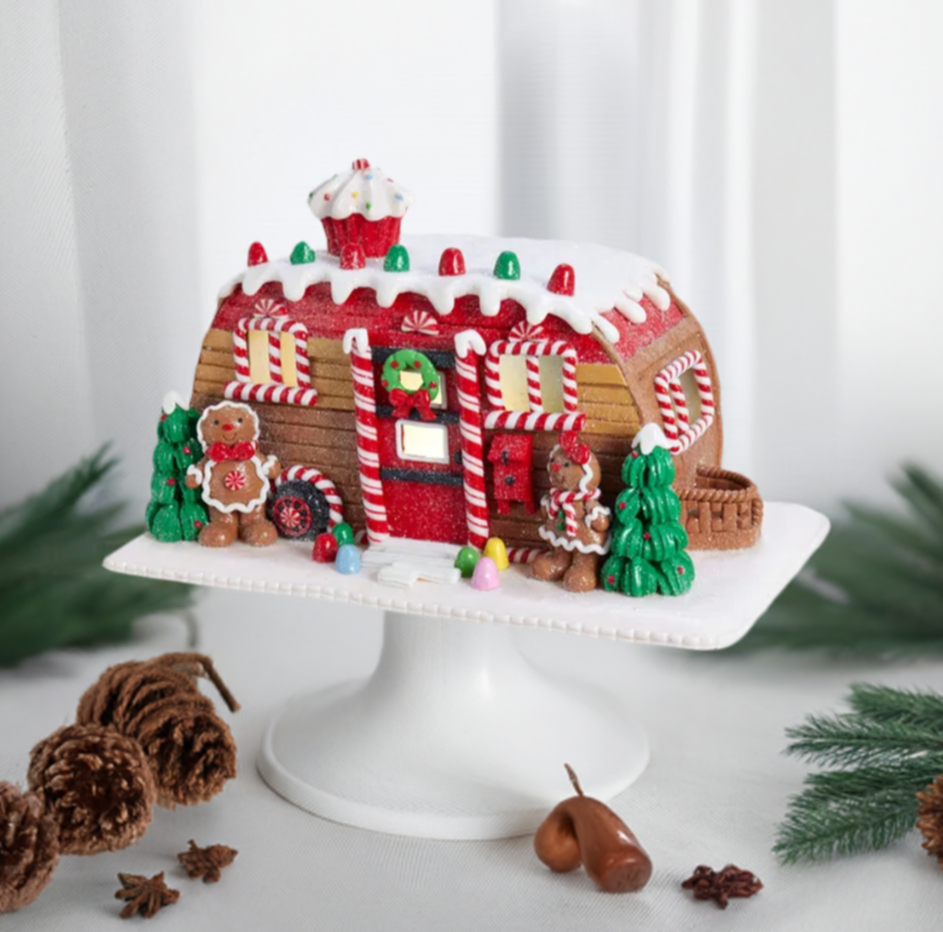 The Canton Christmas Shop 6" Gingerbread Camper LED House by Kurt Adler on pedestal with Christmas kitchen