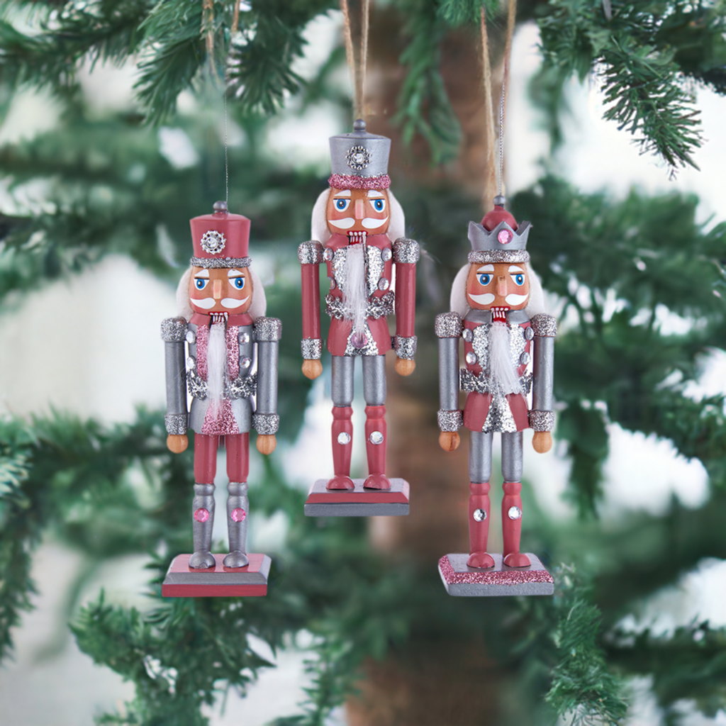 The Canton Christmas Shop 6" Pink and Pewter Nutcracker Ornaments Assorted on pink background