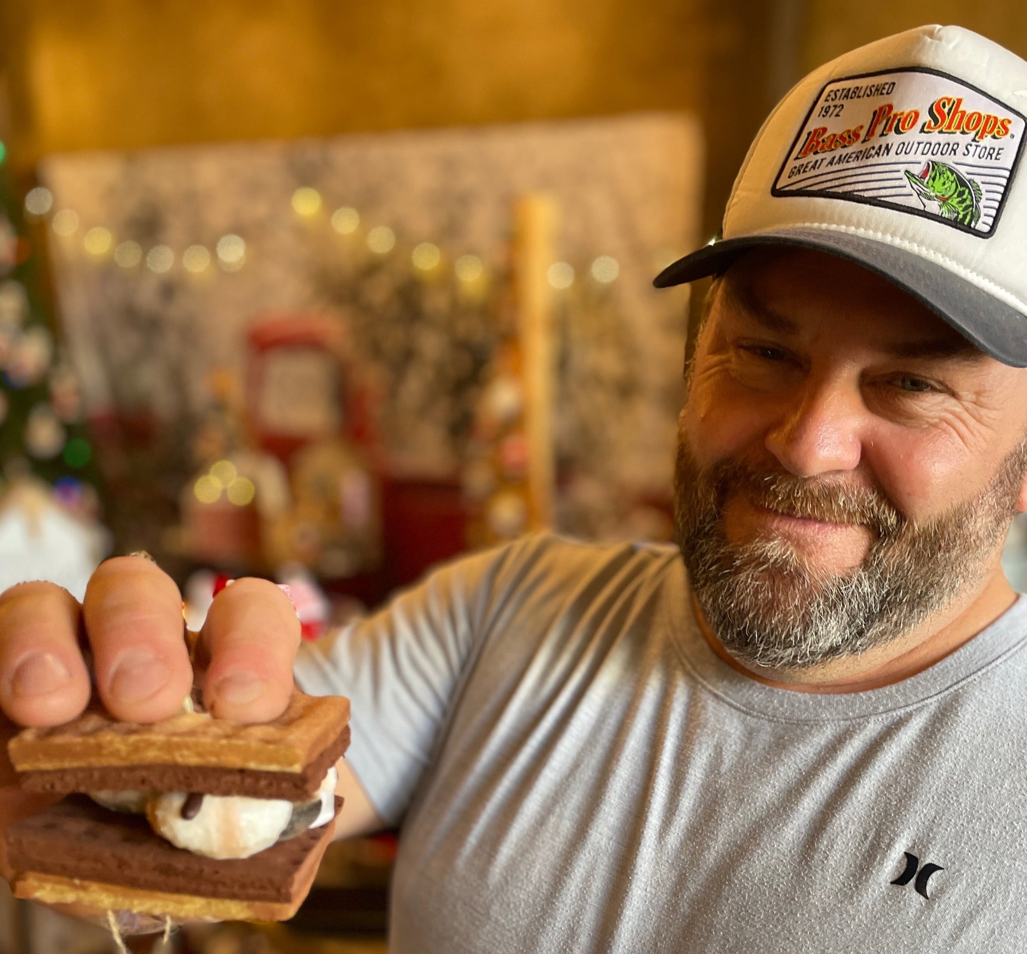 The Canton Christmas Shop S'mores ornament held by customer